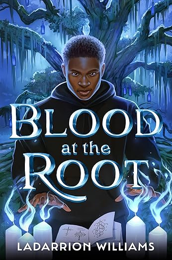 Cover of Blood at the Root by Ladarrion Williams. Blue-tinged night scene of Black male teen standing in front of moss covered tree. Dressed in black, he has his hands placed above white candles emitting blue flames. An open book of magic with diagrams is in front of him.