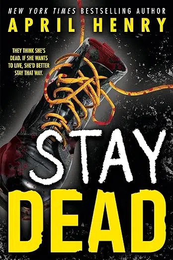 Cover of Stay Dead by April Henry. Black boot with yellow laces covered in blood splatter.