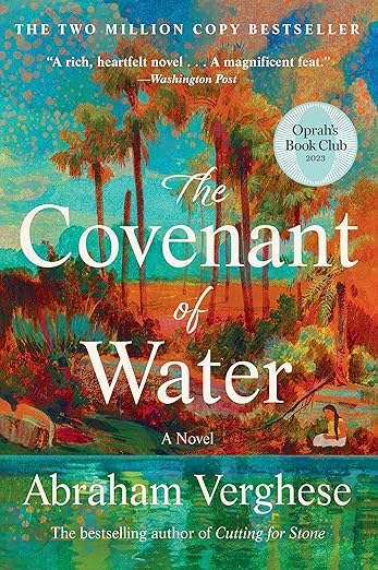 Book cover of “The Covenant of Water” by Abraham Verghese. The artwork shows a vibrant, painterly landscape with tall palm trees, lush greenery, and water in the foreground. Warm oranges, greens, and blues blend to create a tropical setting. A circular badge notes the book is an Oprah’s Book Club 2023 selection.