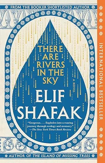 Book cover of “There Are Rivers in the Sky” by Elif Shafak. The design features a large blue teardrop shape filled with gold vertical lines resembling falling rain. The background is cream with intricate blue decorative borders. A vertical orange band on the right reads “International Bestseller.”