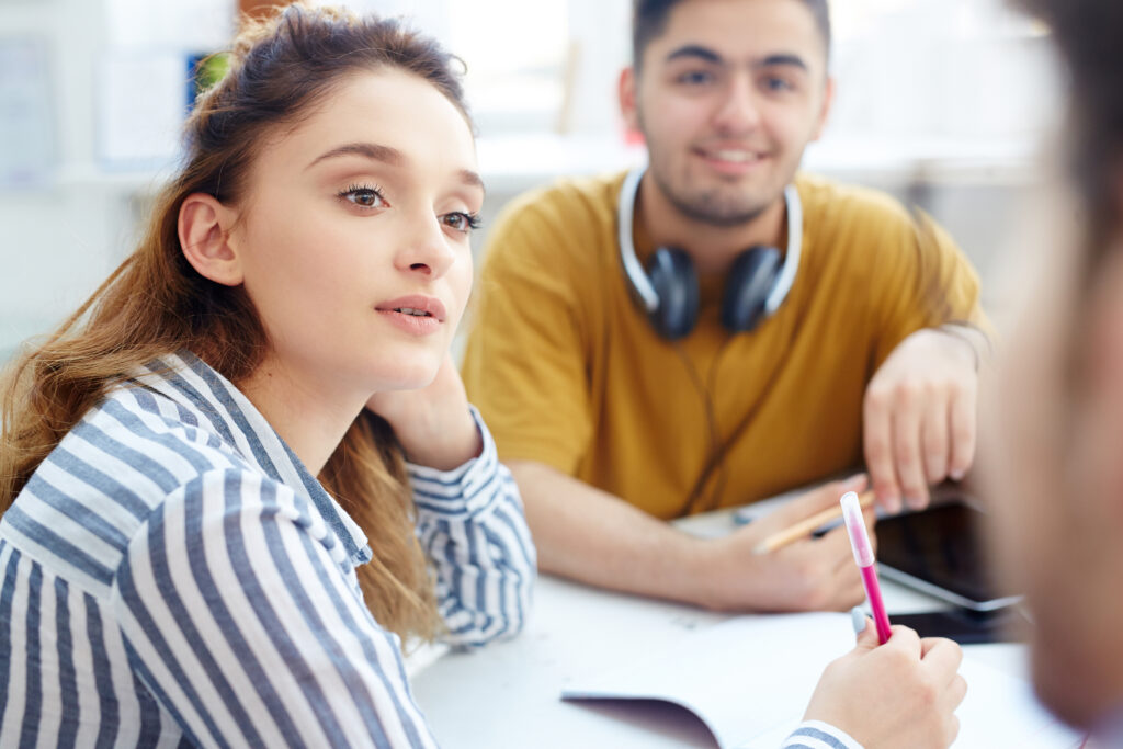 Students engage in a small-group discussion, analyzing a short story with conflict and exploring how the central conflict connects to the story’s theme.